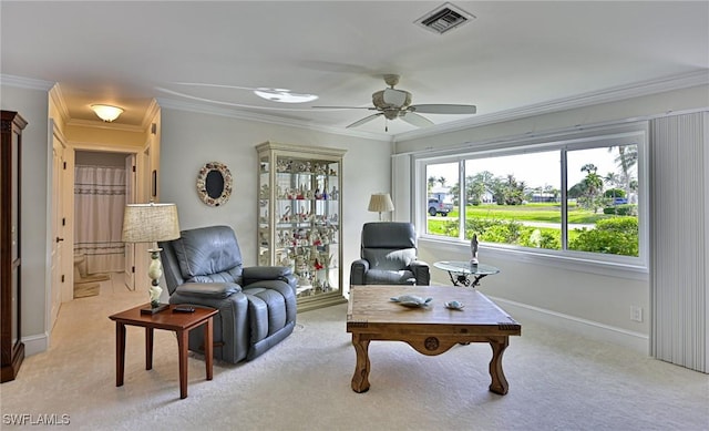 living area with ceiling fan, crown molding, and light carpet