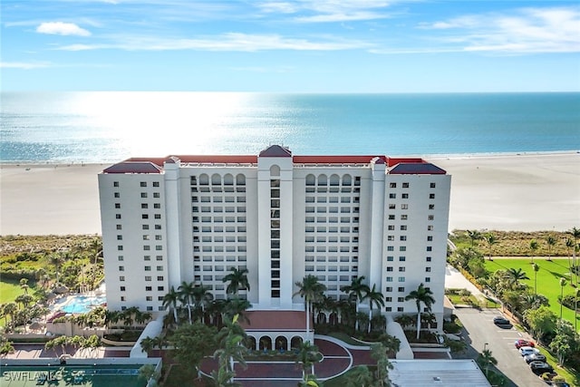 view of property with a beach view and a water view