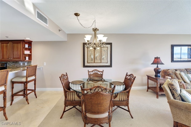 dining space with an inviting chandelier