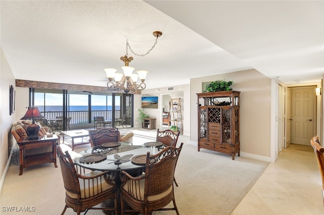 dining space with a water view and a chandelier