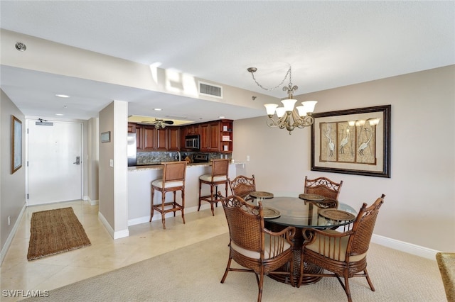 tiled dining area featuring a notable chandelier