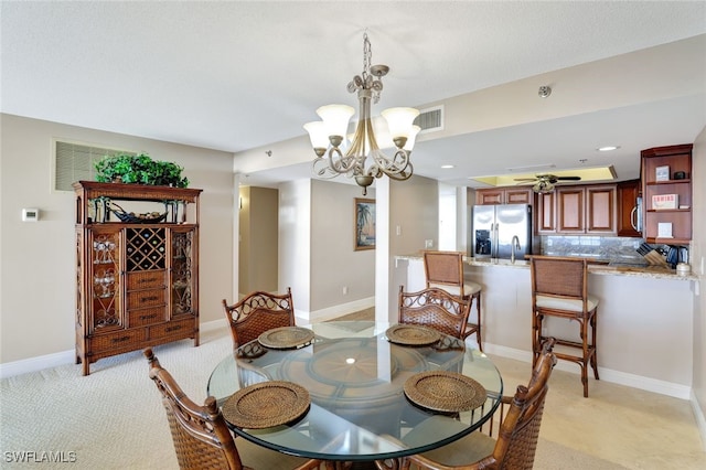 dining room featuring ceiling fan with notable chandelier