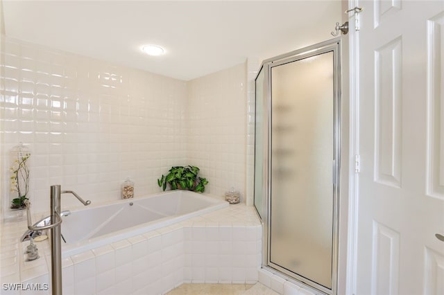 bathroom with shower with separate bathtub