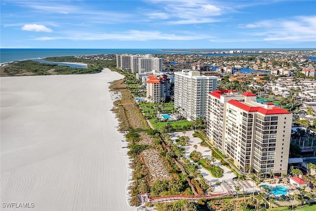 birds eye view of property with a water view and a beach view