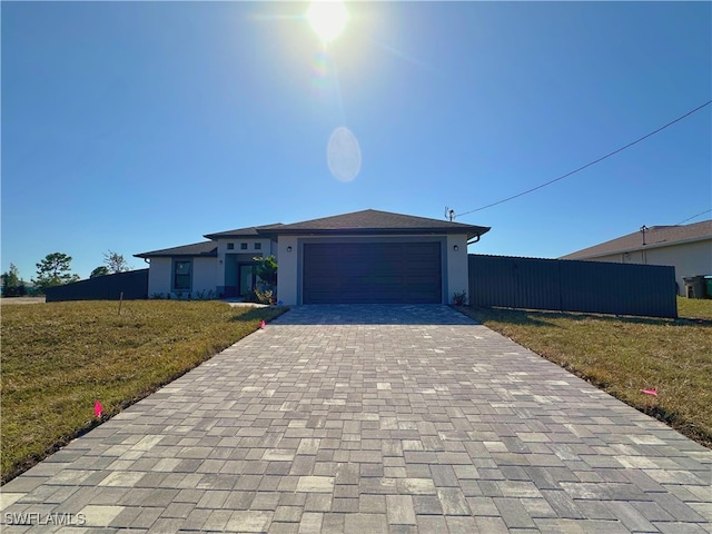 view of front facade featuring a front yard and a garage