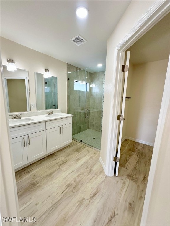 bathroom featuring vanity and an enclosed shower