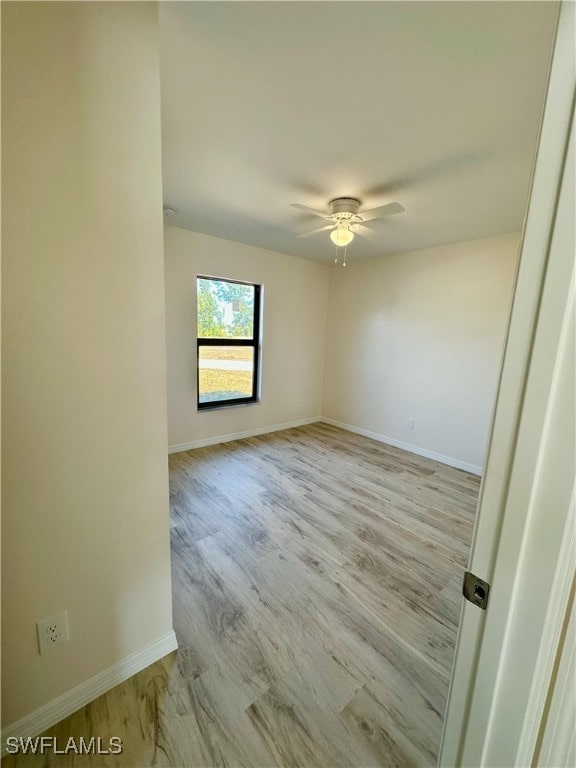 empty room with ceiling fan and light wood-type flooring