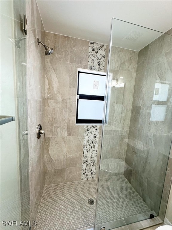 bathroom featuring a shower with shower door