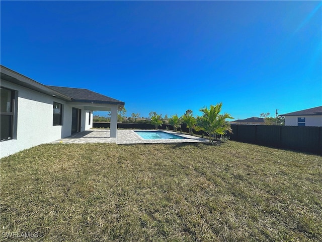 view of yard with a fenced in pool and a patio