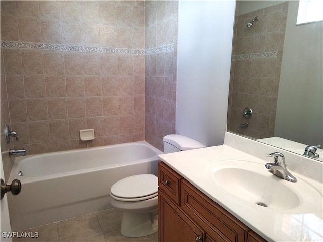 full bathroom with tile patterned flooring, tiled shower / bath combo, toilet, and vanity