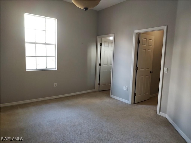 unfurnished bedroom featuring light colored carpet