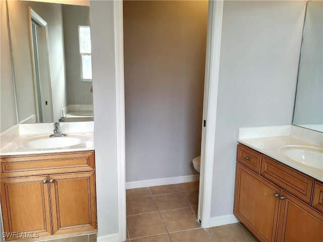 bathroom featuring tile patterned flooring, vanity, and toilet