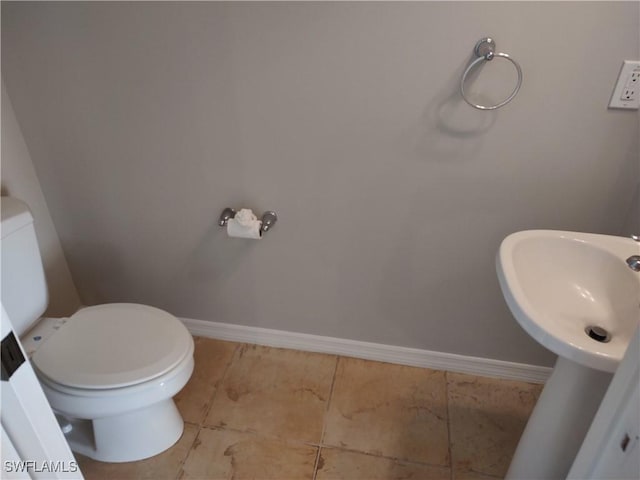 bathroom with sink, tile patterned flooring, and toilet