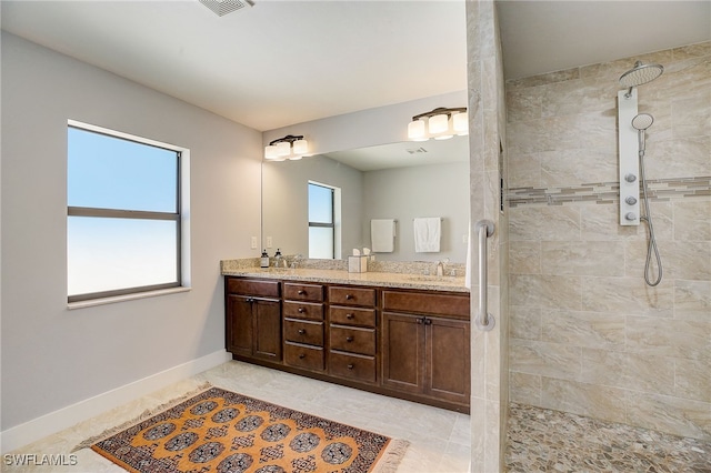 bathroom featuring vanity and tiled shower