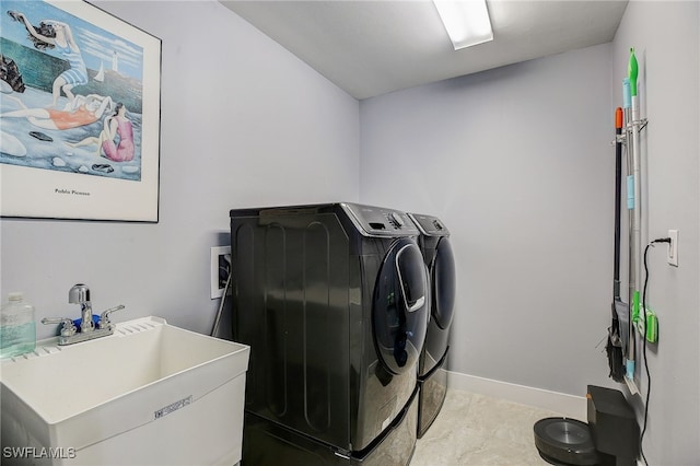 laundry area featuring washer and clothes dryer and sink