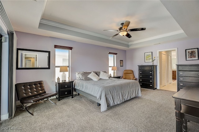 bedroom featuring ceiling fan, a raised ceiling, light colored carpet, and crown molding