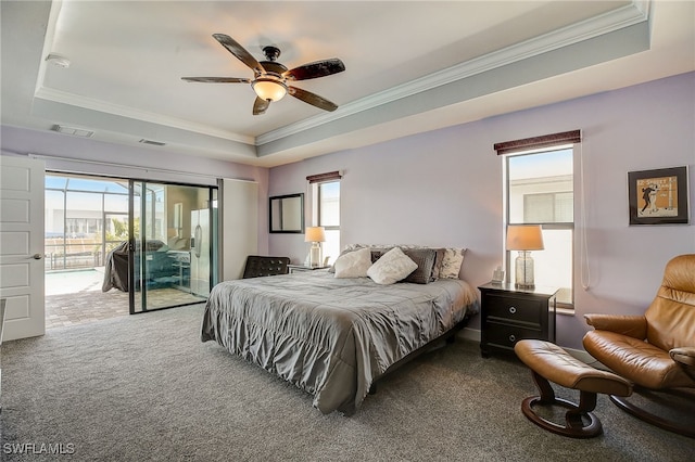 carpeted bedroom featuring a raised ceiling, access to exterior, and ceiling fan