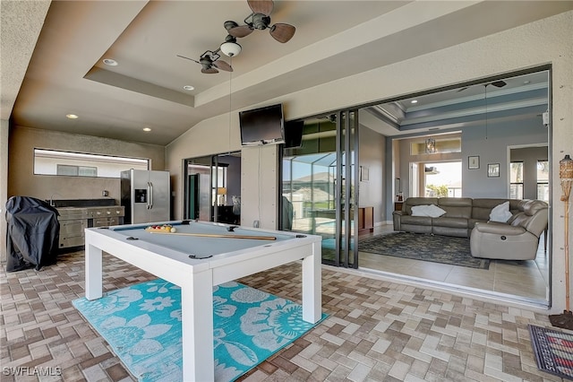 game room featuring a raised ceiling, ceiling fan, ornamental molding, and billiards