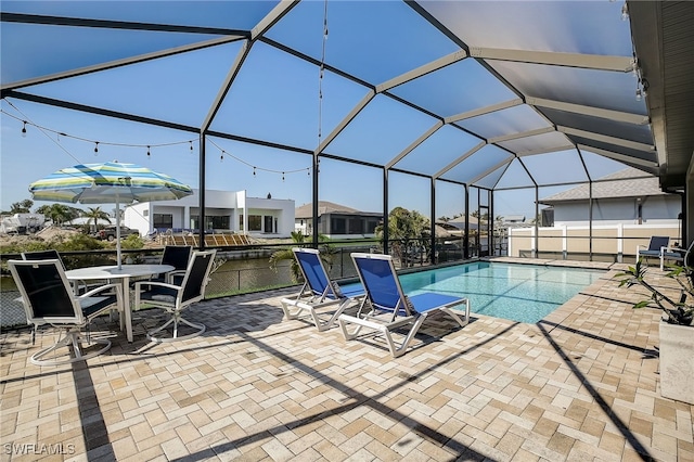 view of swimming pool with a lanai and a patio