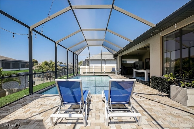 view of swimming pool featuring a lanai and a patio area