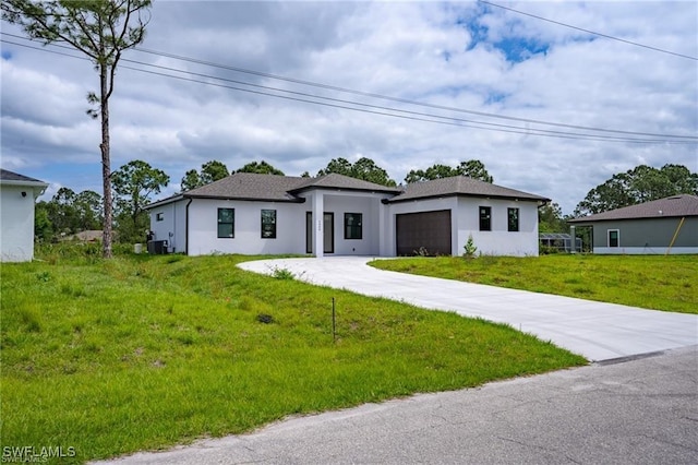 view of front of house with a front yard and a garage