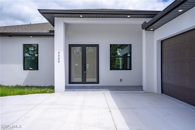 property entrance featuring french doors and a garage