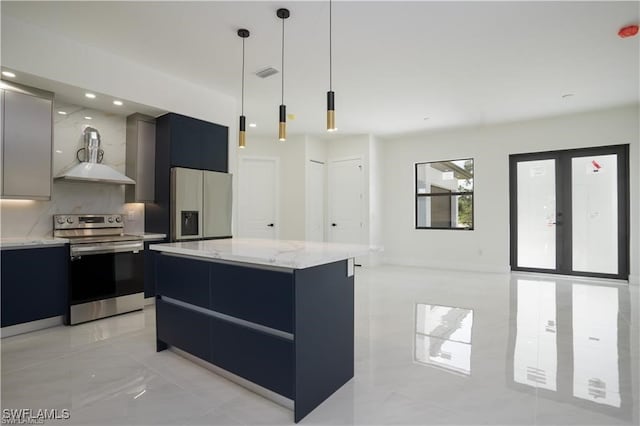 kitchen with decorative backsplash, appliances with stainless steel finishes, wall chimney exhaust hood, pendant lighting, and a kitchen island