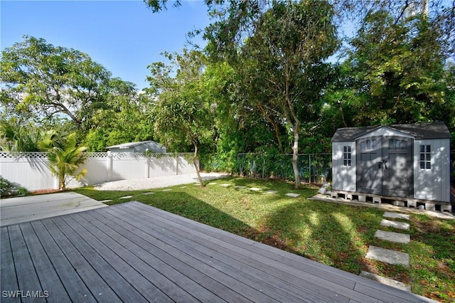 wooden terrace with a shed and a yard