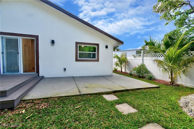 back of house with a patio area and a yard