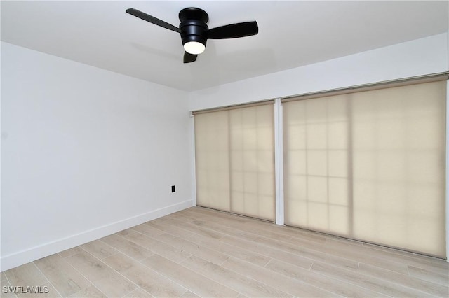 unfurnished bedroom with ceiling fan and light wood-type flooring