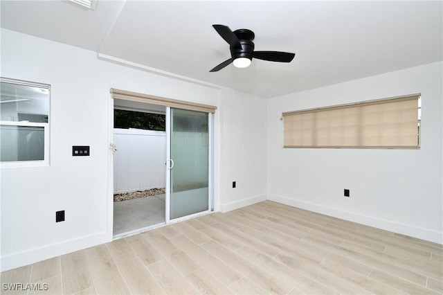 empty room featuring light wood-type flooring and ceiling fan