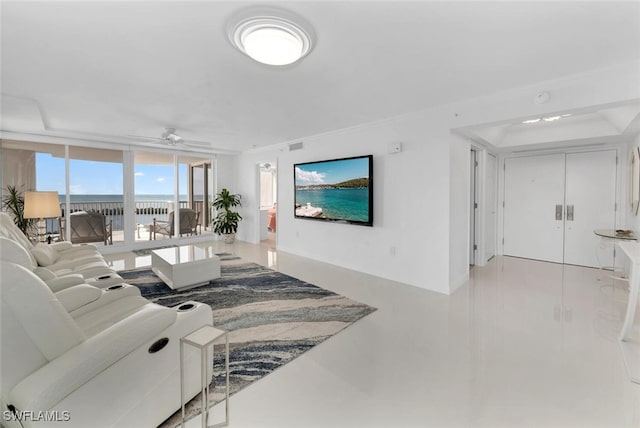 living room with ceiling fan and expansive windows