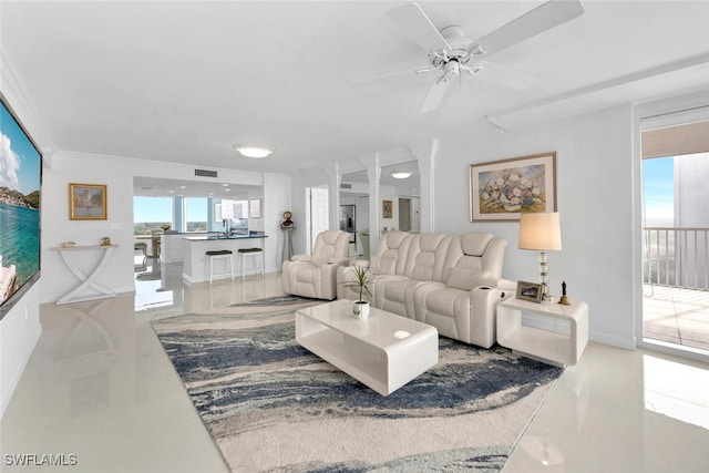 tiled living room featuring ceiling fan