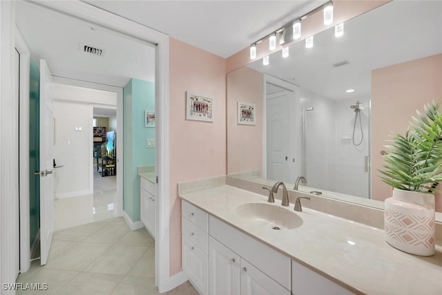 bathroom with walk in shower, tile patterned floors, and vanity