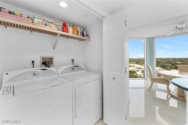 laundry room featuring washing machine and clothes dryer and light tile patterned floors