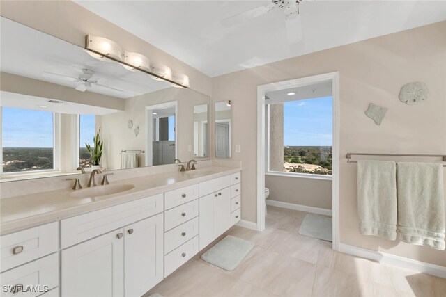 bathroom with ceiling fan, vanity, and toilet