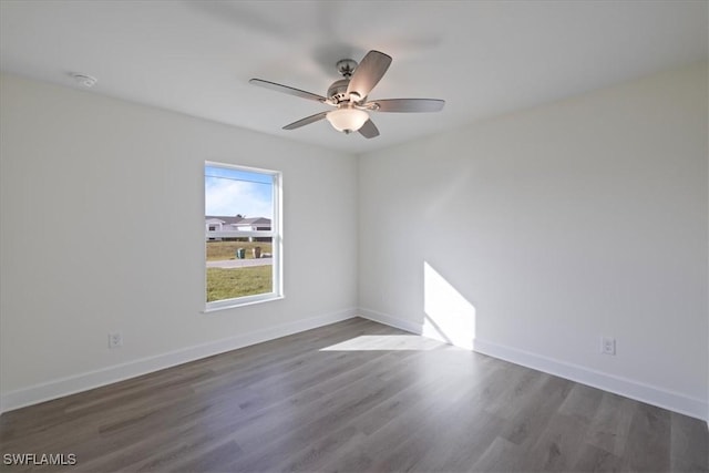 empty room with ceiling fan and dark wood-type flooring