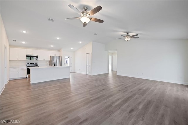 unfurnished living room with light hardwood / wood-style floors, ceiling fan, and lofted ceiling