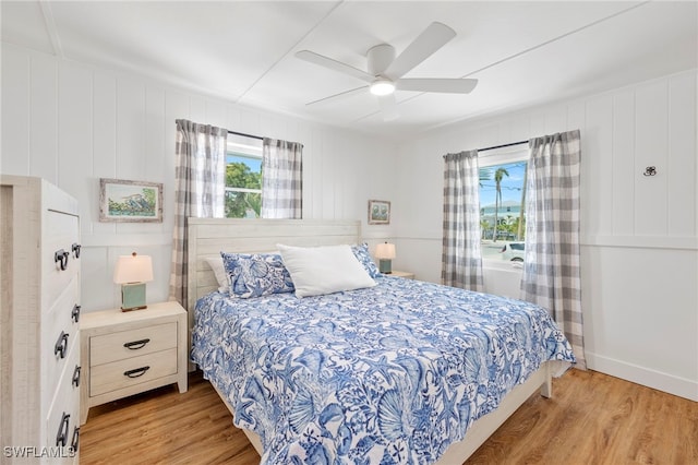 bedroom with multiple windows, ceiling fan, and light wood-type flooring