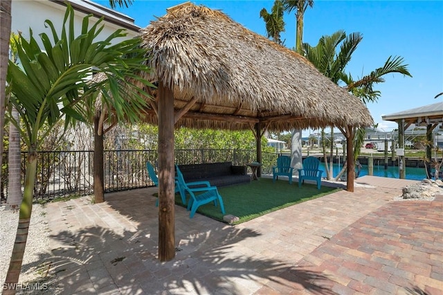 view of patio featuring a gazebo and a water view