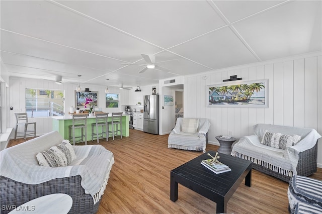 living room with hardwood / wood-style floors and ceiling fan