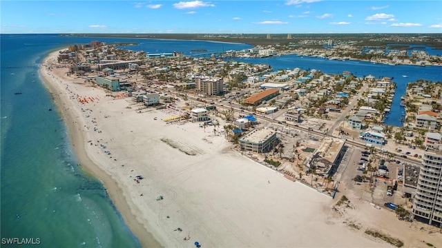 drone / aerial view with a water view and a beach view