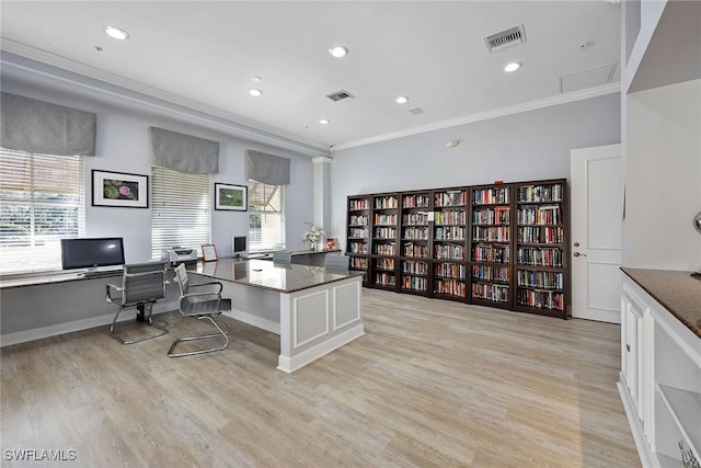 office with crown molding and light hardwood / wood-style flooring