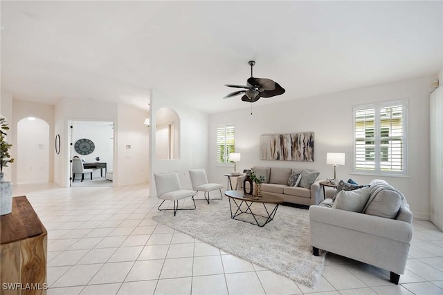 tiled living room with ceiling fan and a healthy amount of sunlight