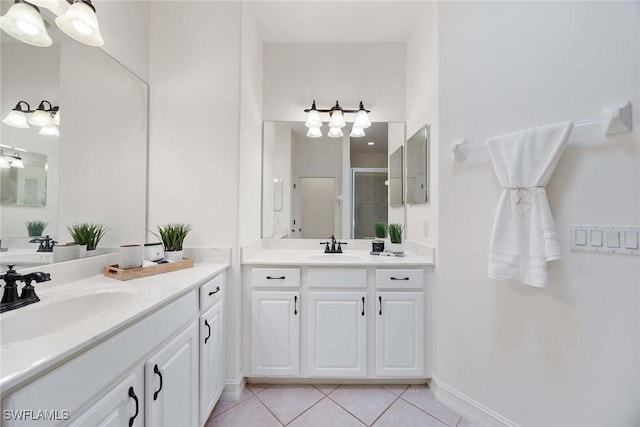 bathroom featuring tile patterned flooring, vanity, and a shower with shower door