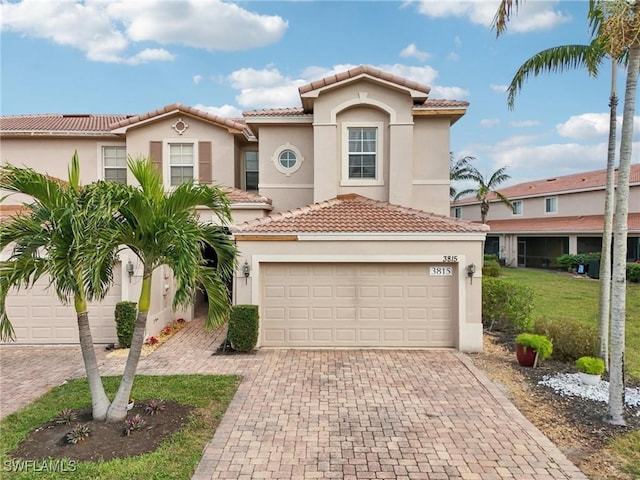 mediterranean / spanish-style home with a garage