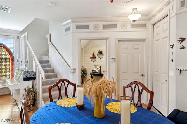 dining space with crown molding