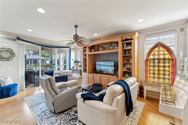 living room with ceiling fan and light hardwood / wood-style floors