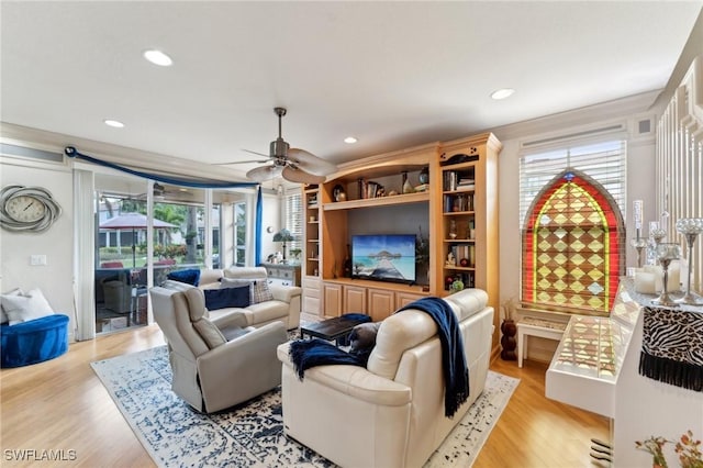 living room featuring ceiling fan, light hardwood / wood-style flooring, and crown molding