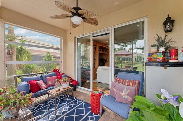 sunroom / solarium featuring ceiling fan